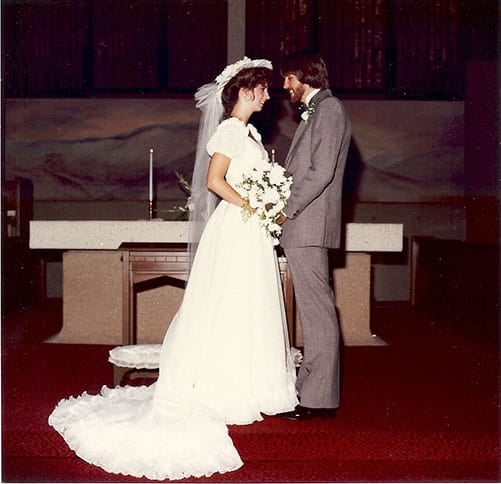 A bride and groom facing each other in a church.