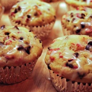 A cutting board covered with muffins.