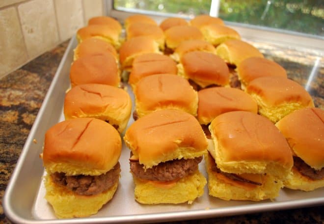 The assembled Turkey Burger Sliders are placed on a metal baking sheet.