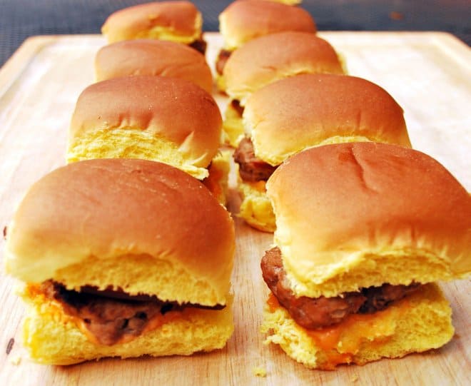 Turkey Burger Sliders lined up on a wooden cutting board.