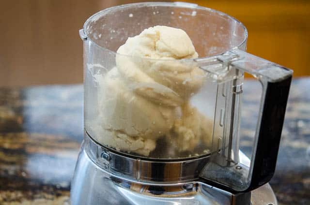 After adding cider vinegar and water, the dough forms a ball in the food processor.