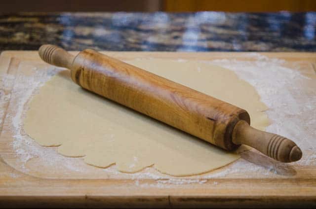 The dough is rolled out with the rolling pin.