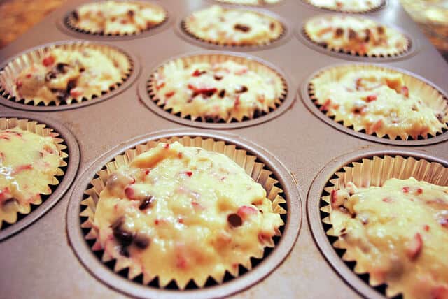 A close up image of the muffin batter in the muffin cups.