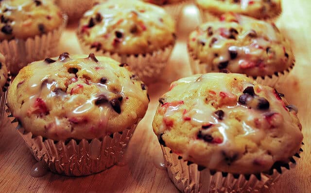 Cranberry Chocolate Chip Muffins on a wooden cutting board.