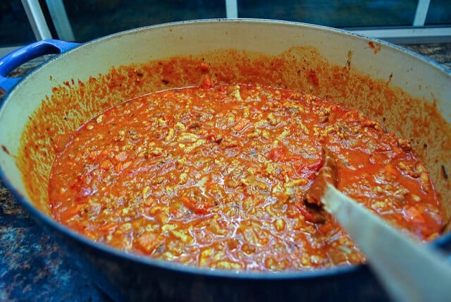 The bolognese sauce simmers in the Dutch oven.