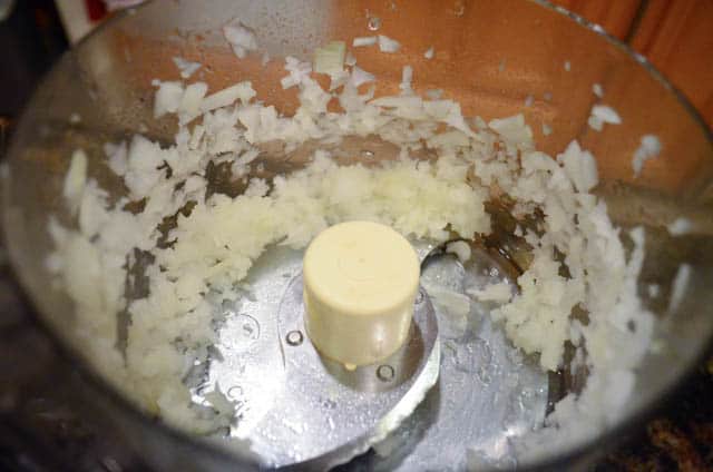 Onion is finely chopped in a food procesor.