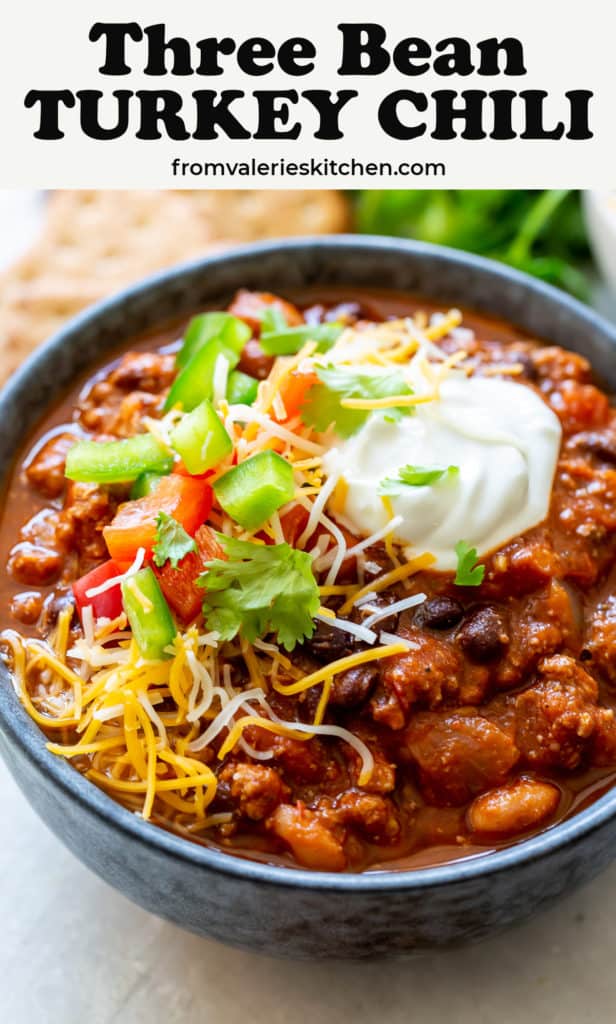 A bowl of Turkey Chili with toppings with text overlay.