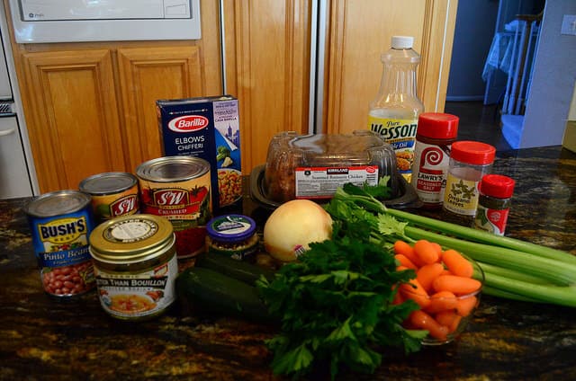 All of the minestrone ingredients arranged on a counter top. 