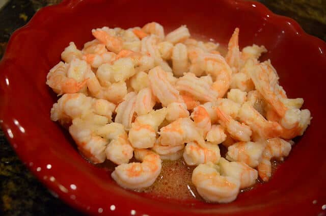 A dish full of cooked shrimp.