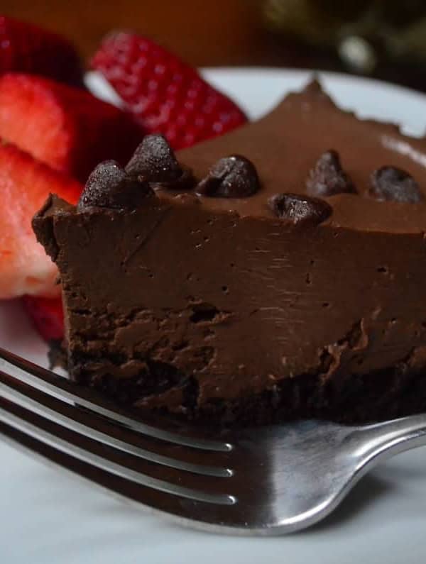 A slice of chocolate pudding tart with strawberries.