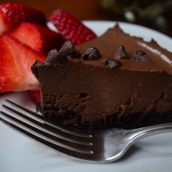A slice of chocolate pudding tart with strawberries.