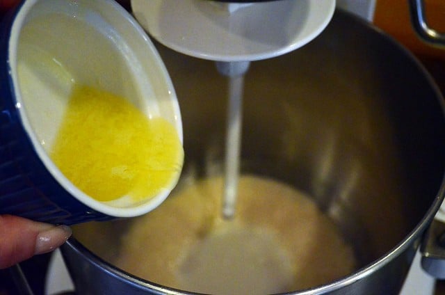 Melted butter being added to the stand mixer bowl.