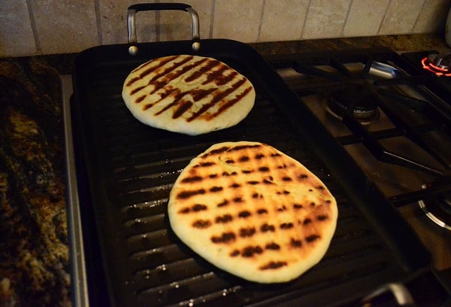 The flipped over bread showing the grill marks made by the stove top grill.