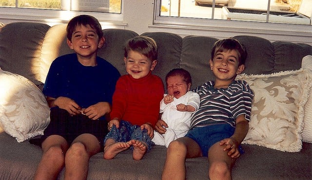 The Boys at a young age sitting on a couch.