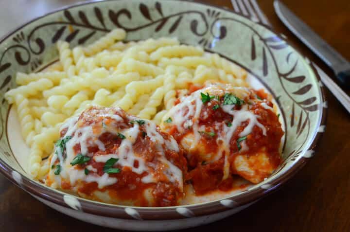 A serving of Pizza Chicken with noodles on the side.