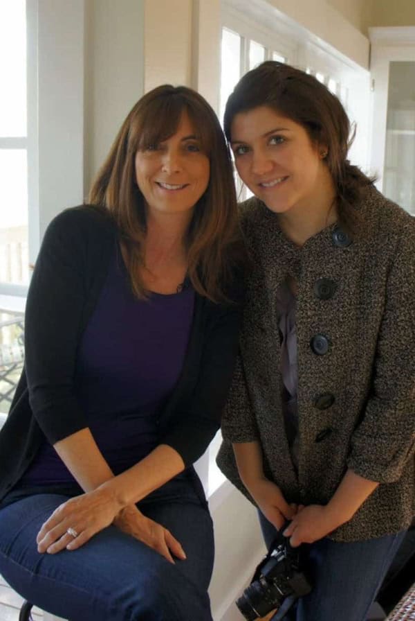 Two women next to each other smiling at the camera.