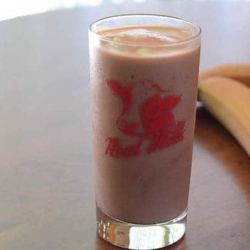 A serving of smoothie in a glass.