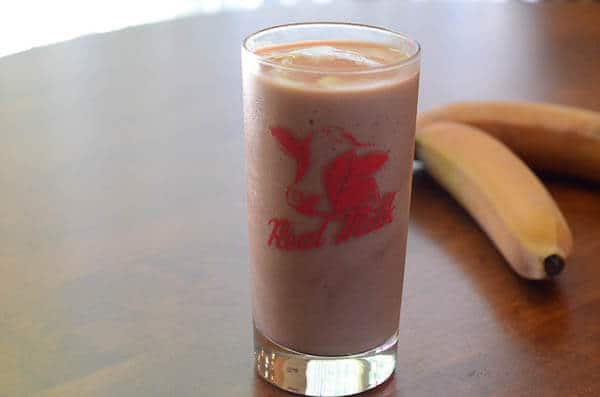 A serving of smoothie in a glass.