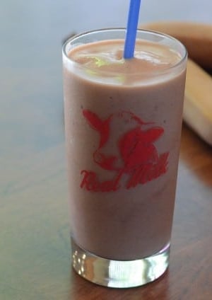 A serving of smoothie in a glass.