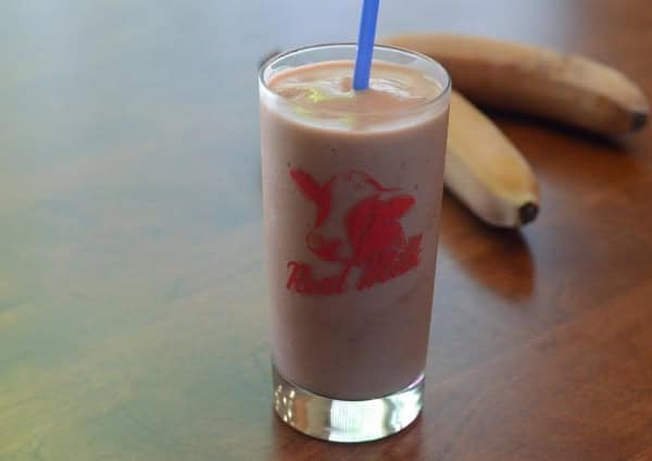A serving of smoothie in a glass.