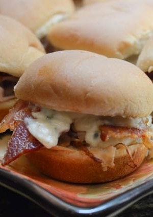 A close up of a slider with turkey and bacon.