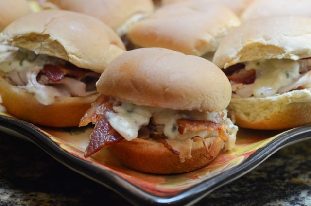 A close up of a slider with turkey and bacon.