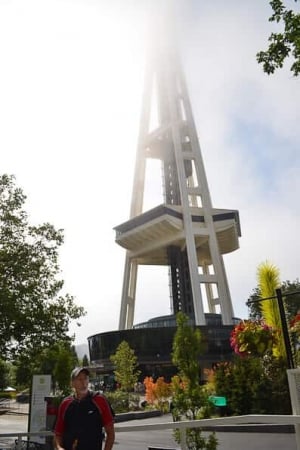 A man standing in front of the space needle in Seattle.