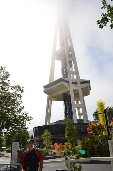 A man standing in front of the space needle in Seattle.