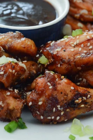 A plate of chicken wings with a dipping sauce.