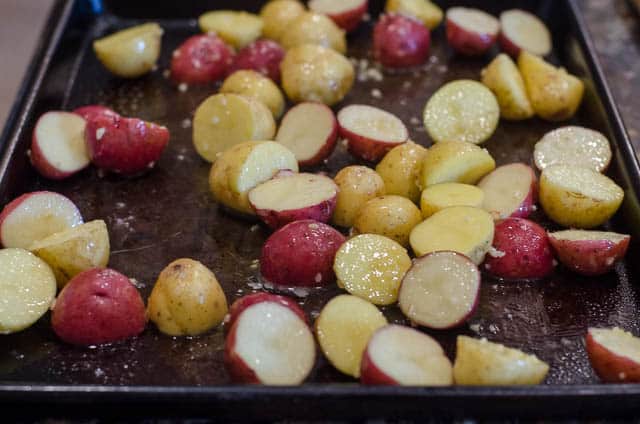A baking sheet filled with the prepared potatoes.