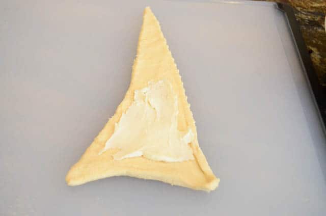The mascarpone mixture is spread on a triangle of dough.