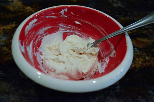 A bowl of mascarpone cheese combine with sugar and vanilla.