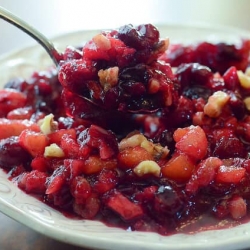 A spoon scoops up some Cranberry Apricot Chutney.