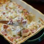 A knife lifts some kielbasa dip from a serving dish.