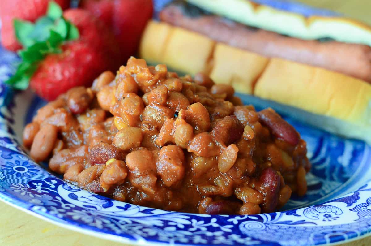A close up of a serving of Spicy Baked Beans on a blue plate.
