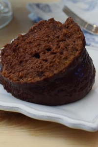 A piece of black russian bundt cake on a white plate.