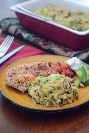 Chicken and rice on a yellow plate.