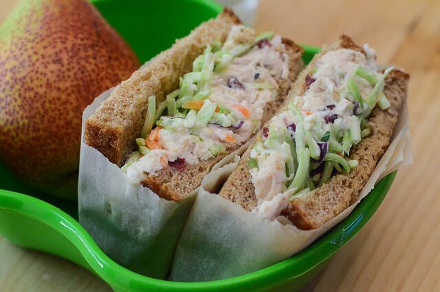 A closeup image of a Crunchy Sweet Chicken Salad Sandwich with broccoli slaw.