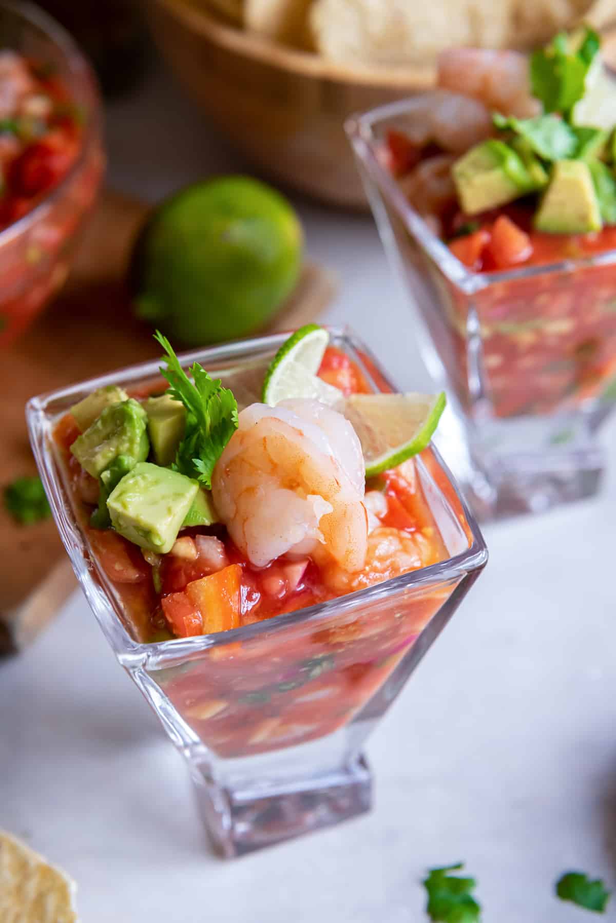 Coctel de camaron with avocado and lime in a square margarita glass.