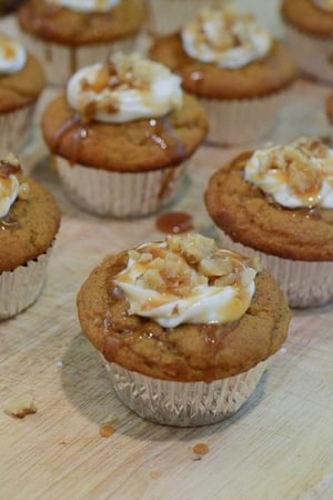 Cupcakes with a creamy frosting and nuts on top.
