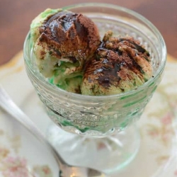 A glass dish filled with ice cream, creme de mente, and sprinkled with ovaltine.