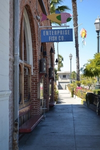 A sign that says Enterprise Fish Co above a brick building.