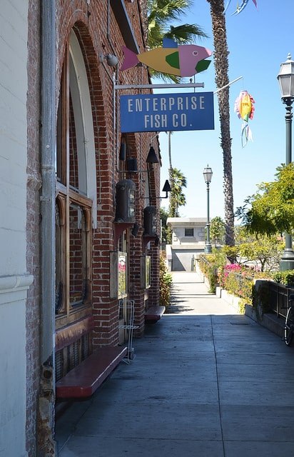 A sign that says Enterprise Fish Co above a brick building.