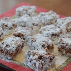 Apricot Bars dusted with powdered sugar on a napkin.