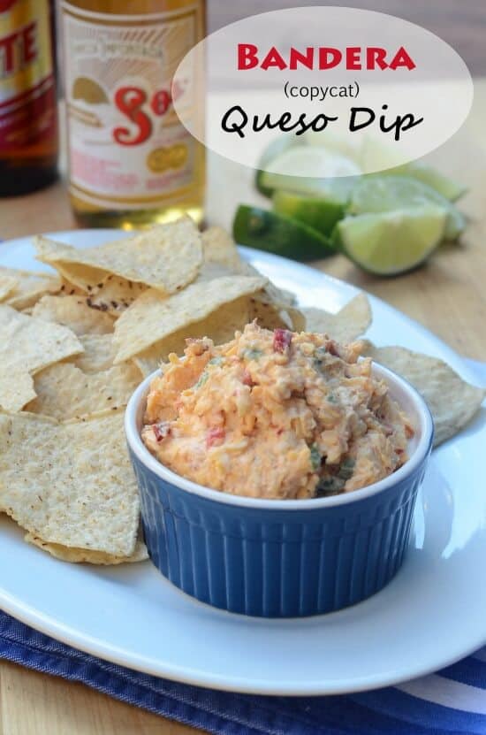 A blue ramekin filled with a cheese dip next to tortilla chips.