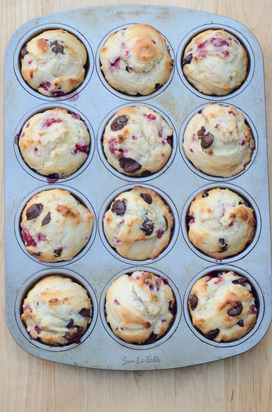 Raspberry Dark Chocolate Muffins in a muffin pan shot from over the top.