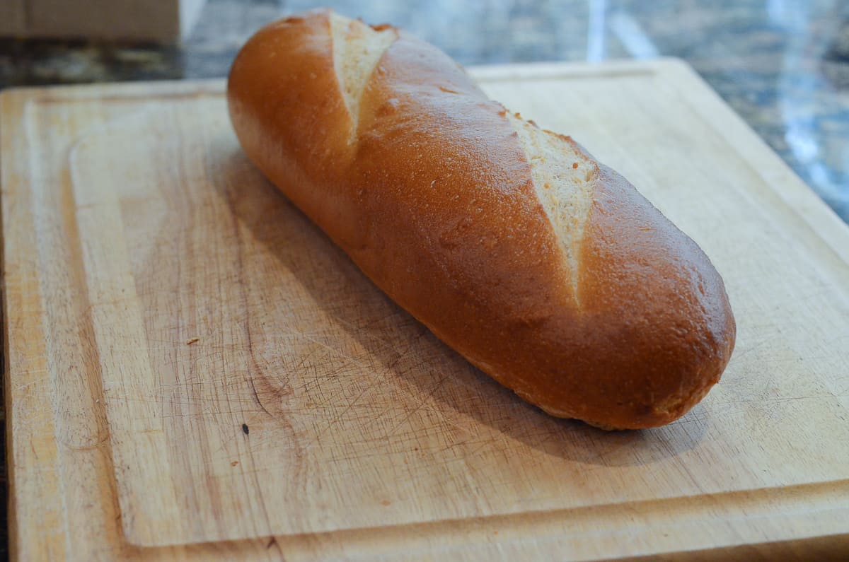 A loaf of French bread on a cutting board.