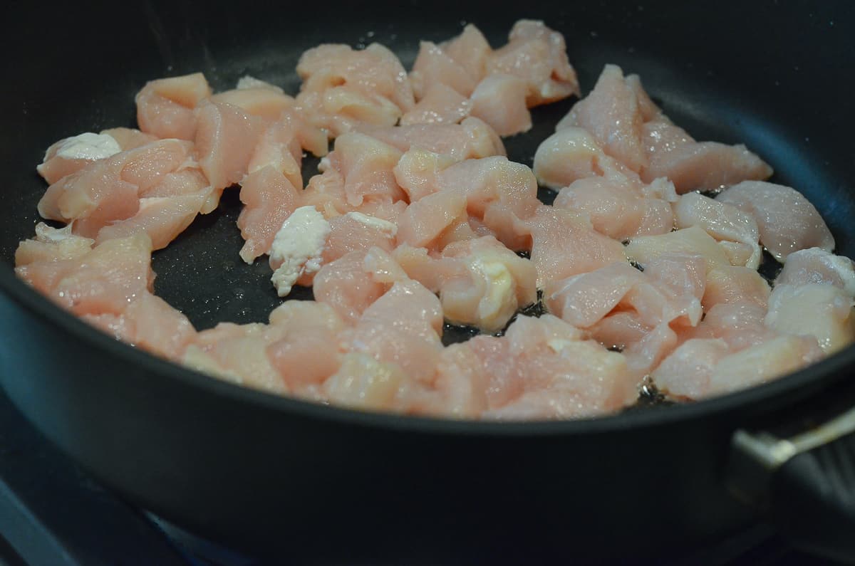 Chicken cooking in a skillet.