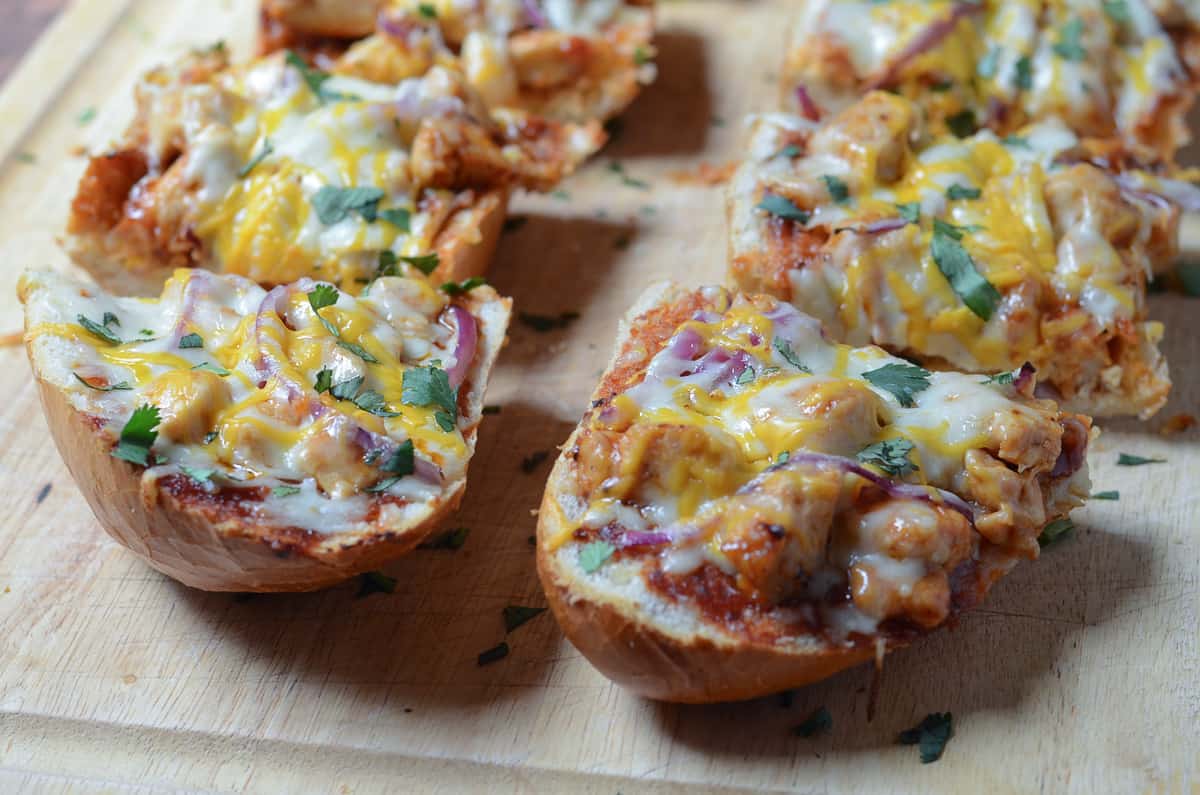 BBQ Chicken French Bread Pizza sliced on a cutting board.