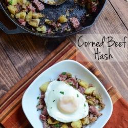 A plate of corned beef hash with a fried egg on top.